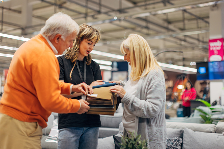 A senior man and a senior woman shopping in a furniture store