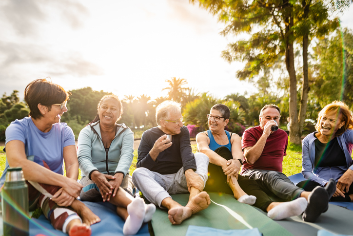 Seniors friends sitting together outside